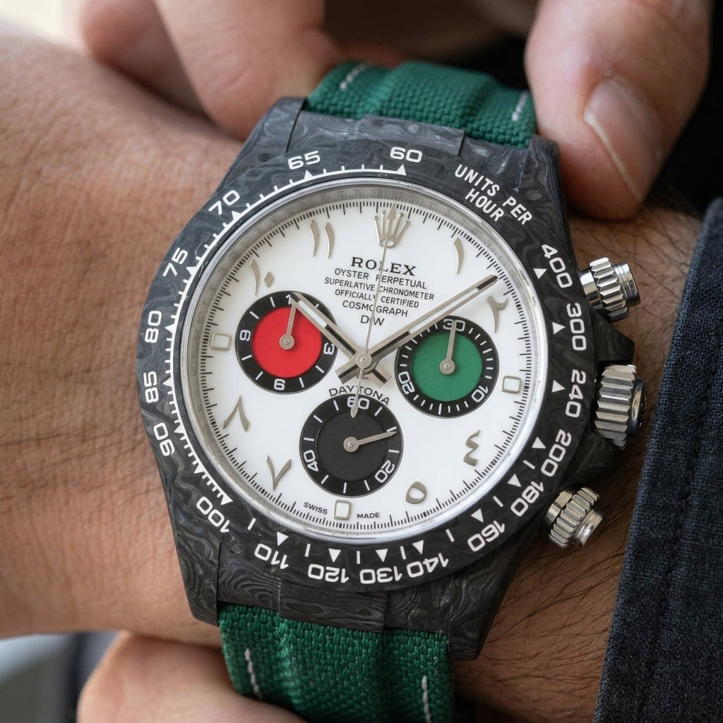 Forged-carbon chronograph with a white dial and Arabic numerals on the wrist as a shirt cuff is fastened