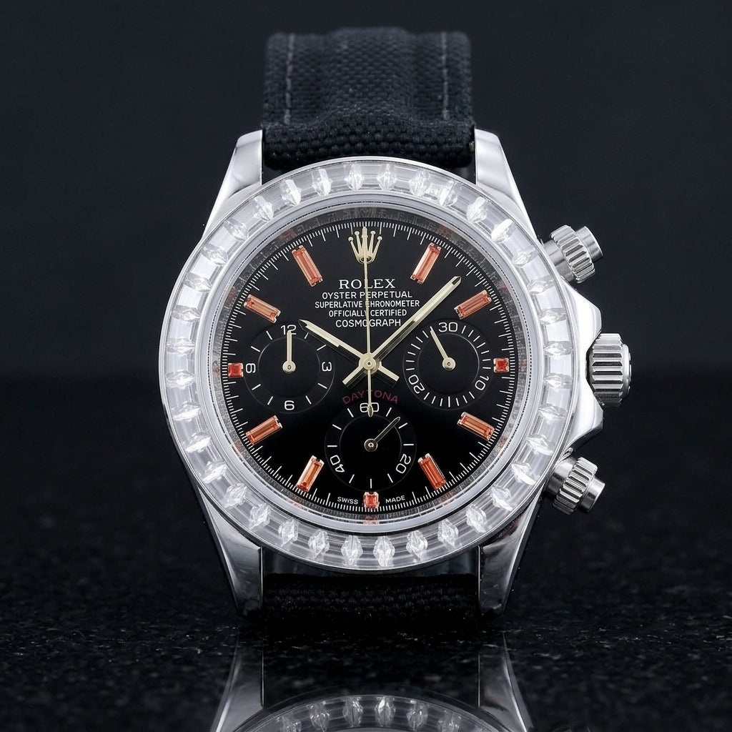 Steel chronograph with a black dial on its black canvas strap, worn on the wrist below a dark suit cuff