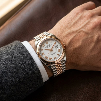 The Datejust 41 worn on the wrist beneath a tailored shirt cuff