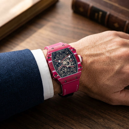 The Raspberry Tonneau worn on the wrist beneath a tailored shirt cuff