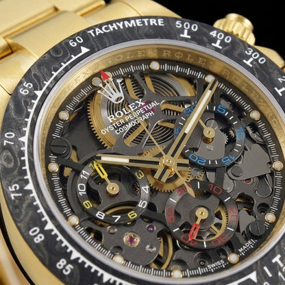 Macro of the skeleton dial: dark gunmetal movement, gold wheels, and yellow, blue and red counters
