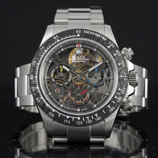 Steel skeleton chronograph with a marbled forged-carbon bezel and yellow, blue and red counters, upright on polished black granite