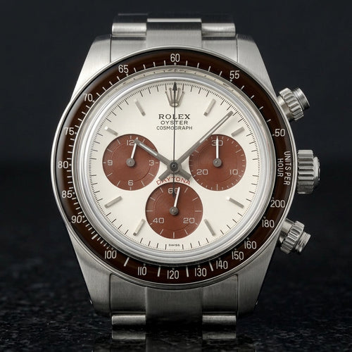 Steel chronograph with a white dial, brown counters and a brown bezel, upright on polished black granite