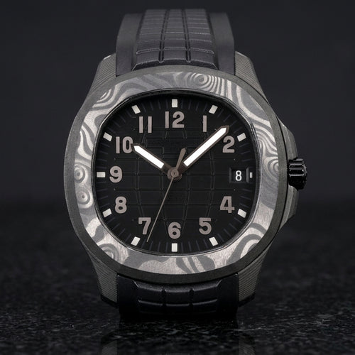 Forged-carbon watch with a black grid dial and gunmetal-grey numerals, upright on polished black granite