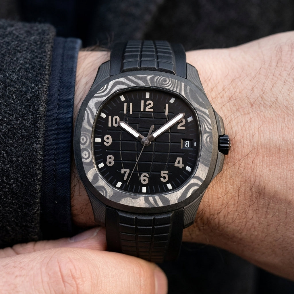 Forged-carbon watch with a black dial and gunmetal-grey numerals on the wrist as a shirt cuff is fastened