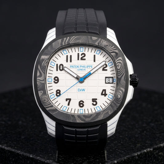 White carbon grid-dial watch with a black marbled bezel and blue hour markers on a black rubber strap, upright on polished black granite