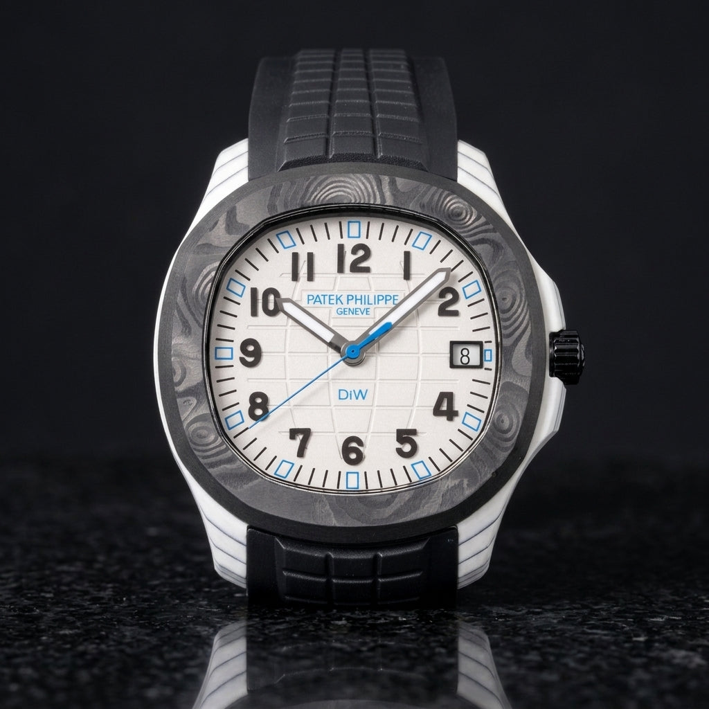 White carbon watch with a black bezel on a black rubber strap, worn on the wrist below a navy suit cuff