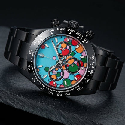 Turquoise bubble-dial chronograph at a three-quarter angle on dark slate, its glossy black bezel carrying white numerals