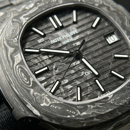 Macro of the forged carbon dial, horizontal grooves breaking its silver-white marbling into stripes, with black-framed white lume batons