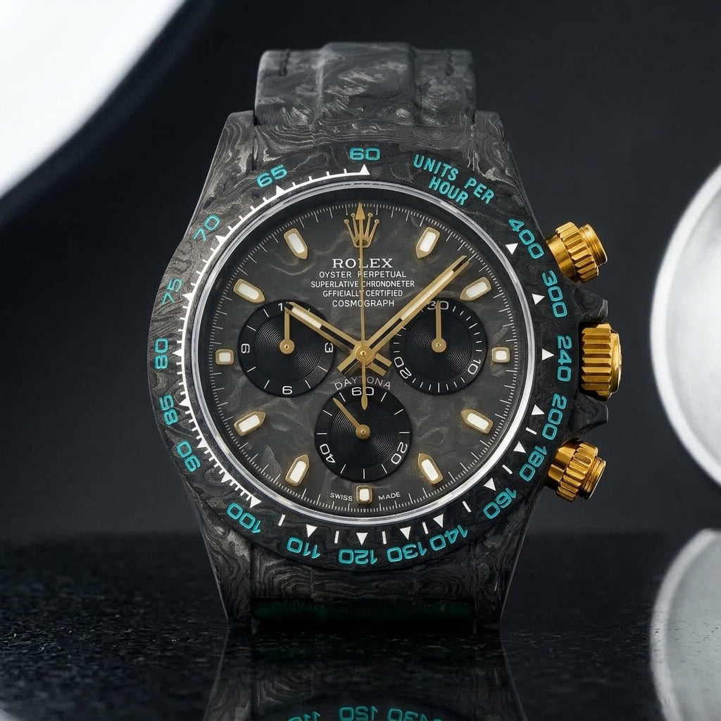 Forged-carbon chronograph with a carbon dial and gold fittings on pale stone