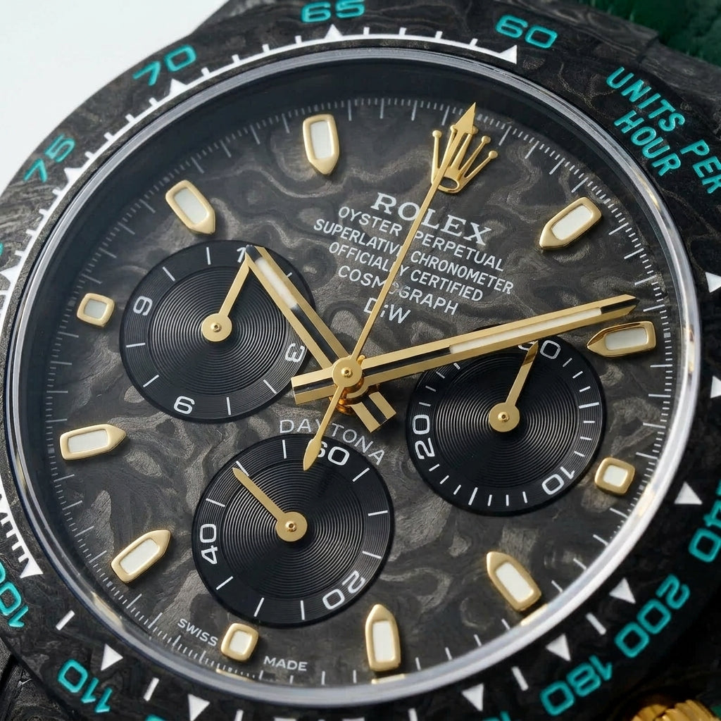 Macro of the marbled carbon dial, gold markers and turquoise bezel numerals
