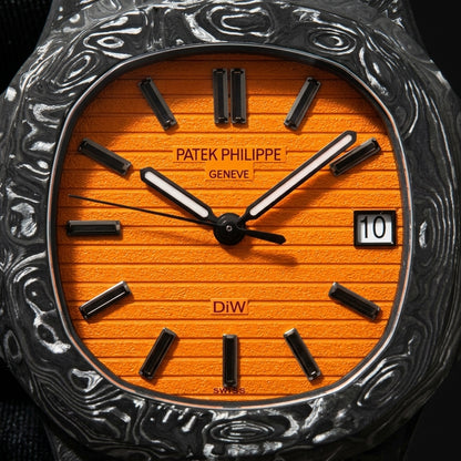Macro of the grooved orange dial, its faceted black baton markers and white-lumed hands