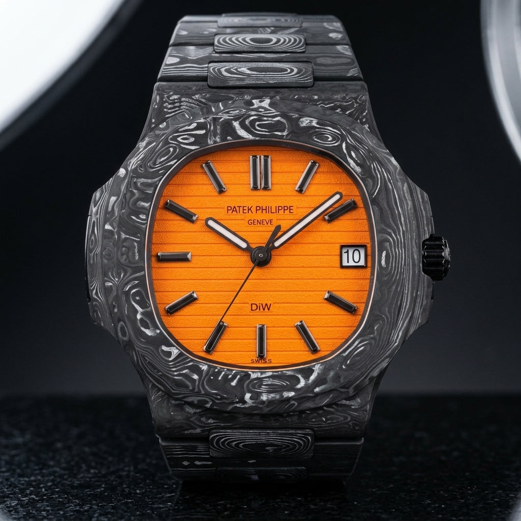 Orange-dial forged carbon sports watch on its black and silver-white carbon bracelet, worn on the wrist below a navy suit cuff