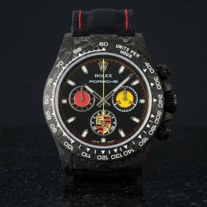 Black forged-carbon chronograph with red and yellow counters on black granite