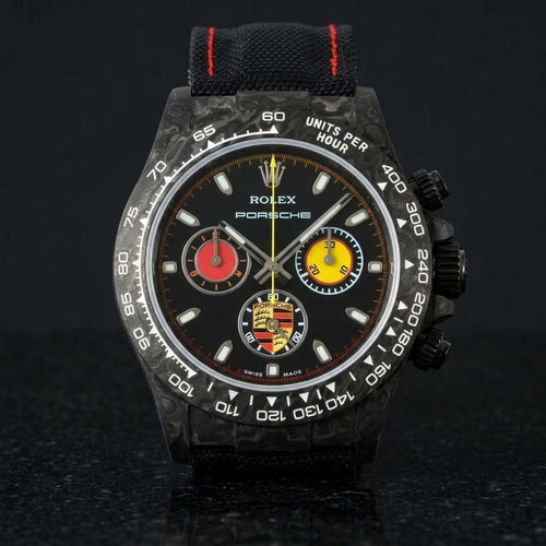 Black forged-carbon chronograph with red and yellow counters on black granite