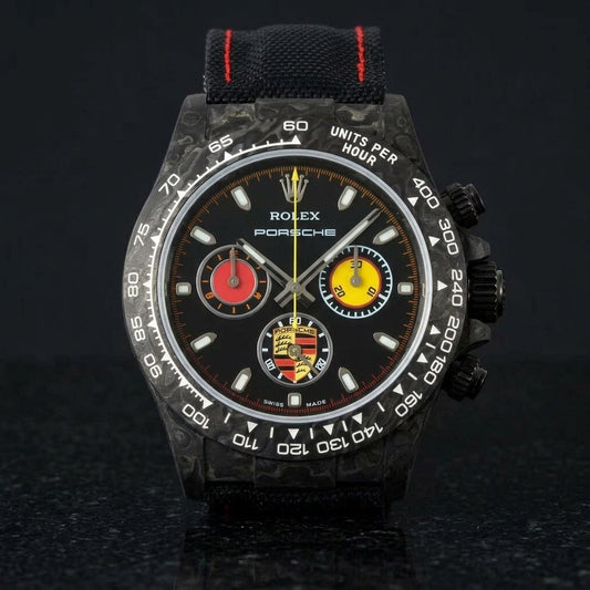 Black forged-carbon chronograph with red and yellow counters on black granite
