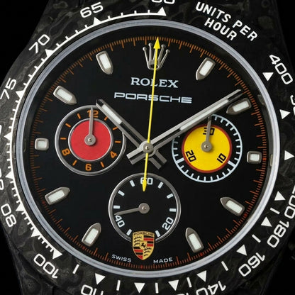 Macro of the matte black dial with its red and yellow chronograph counters