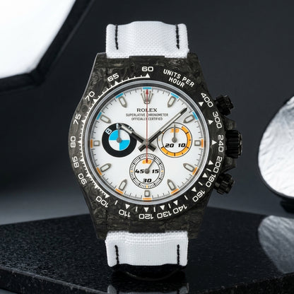 Black forged-carbon chronograph with a white dial on black granite