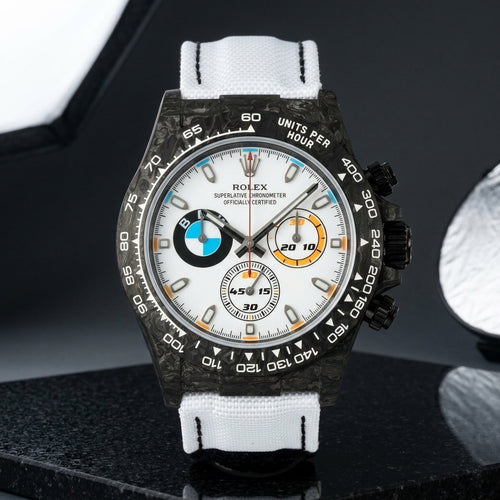 Black forged-carbon chronograph with a white dial on black granite