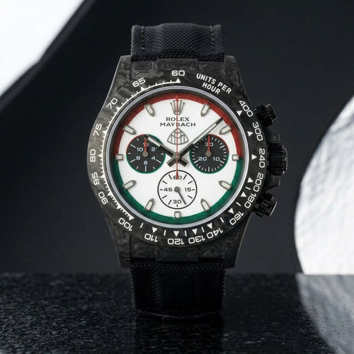 Black forged-carbon chronograph with a red and green ringed dial on black granite