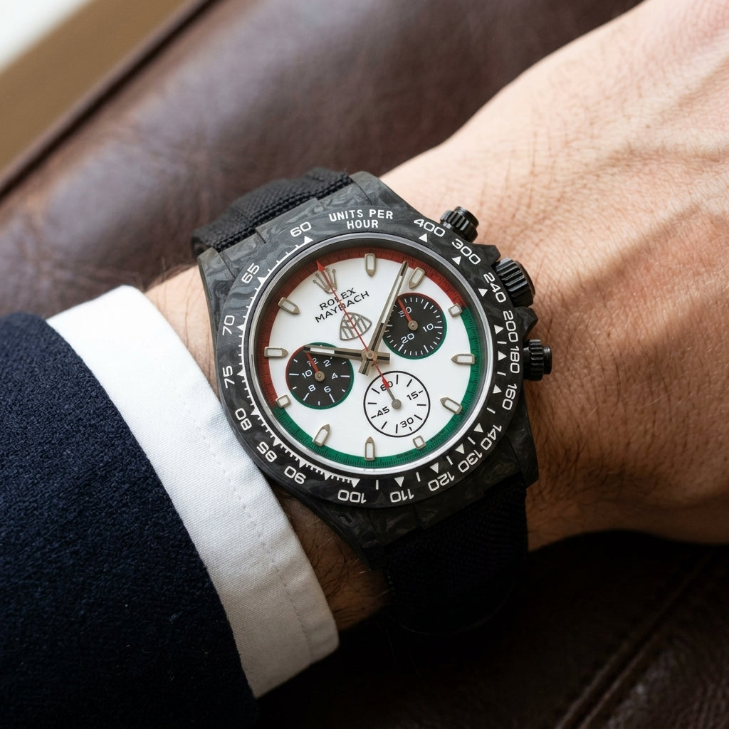 Black forged-carbon chronograph on a black strap worn under a suit cuff