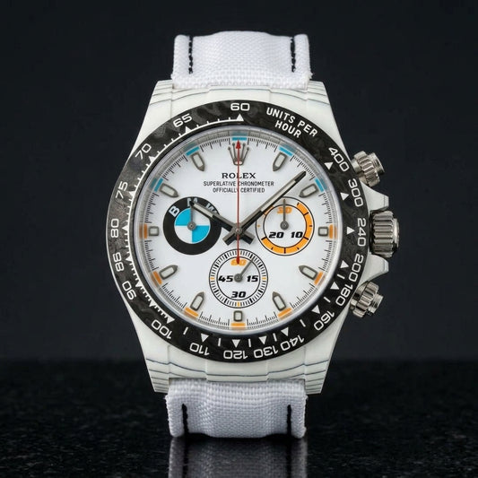White forged-carbon chronograph with a white dial on black granite