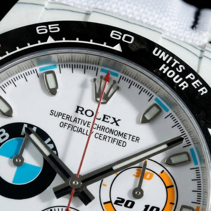 Macro of the white dial, its orange counter and the black tachymeter bezel