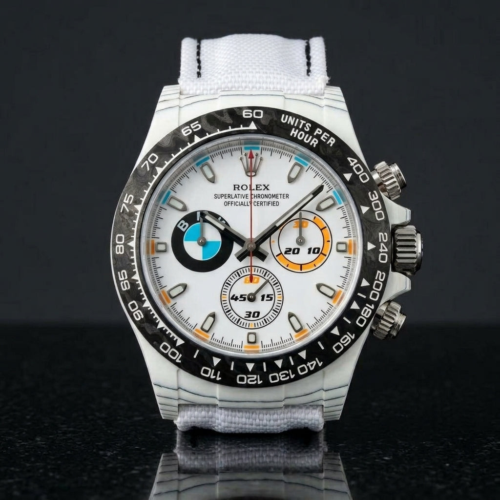 White forged-carbon chronograph on a white strap worn under a suit cuff