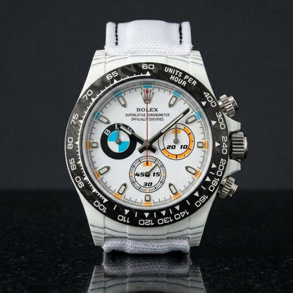 White forged-carbon chronograph on a white strap worn under a suit cuff