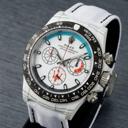 White forged-carbon chronograph at a three-quarter angle on dark slate