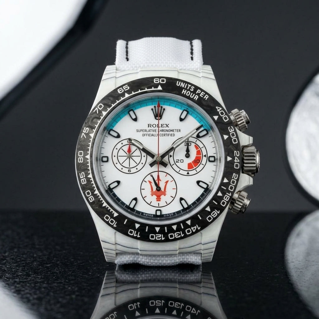 White forged-carbon chronograph on a white strap worn under a suit cuff