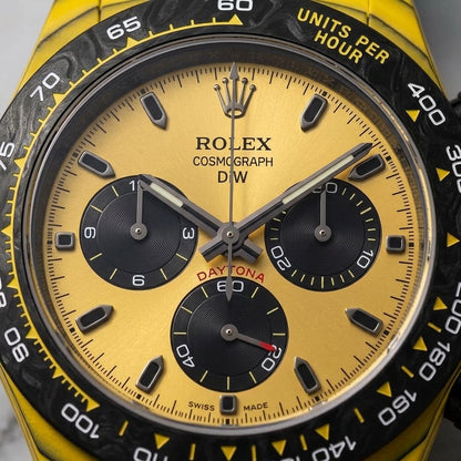 Macro of the golden-yellow dial and its three black counters inside the black marbled bezel