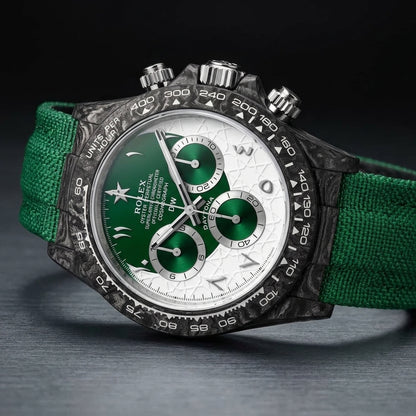 Forged-carbon chronograph at a three-quarter angle, green sun-brushed counters and green strap visible
