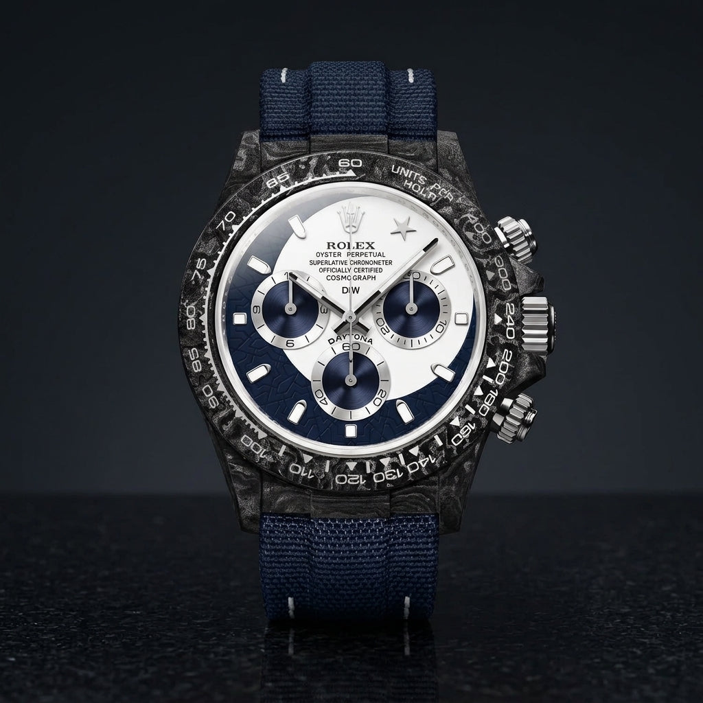 Forged-carbon chronograph with a white and navy dial and a star at twelve, on dark stone
