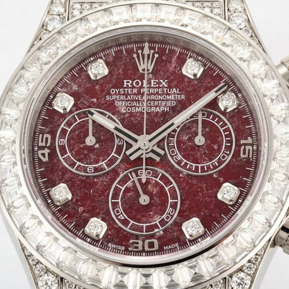 Macro of the red stone dial, three counters and the baguette-set bezel
