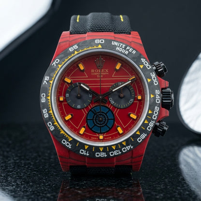 Red forged-carbon chronograph with a red dial and carbon tachymeter bezel on pale stone