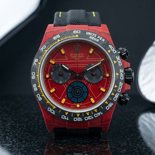 Red forged-carbon chronograph with a red dial and carbon tachymeter bezel on pale stone