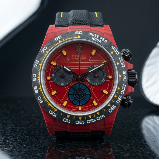 Red forged-carbon chronograph with a red dial and carbon tachymeter bezel on pale stone