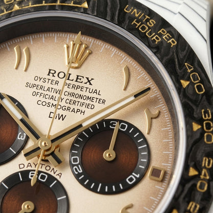 Macro of the cream dial with applied gold Eastern Arabic numerals and three chocolate-brown counters in black rings