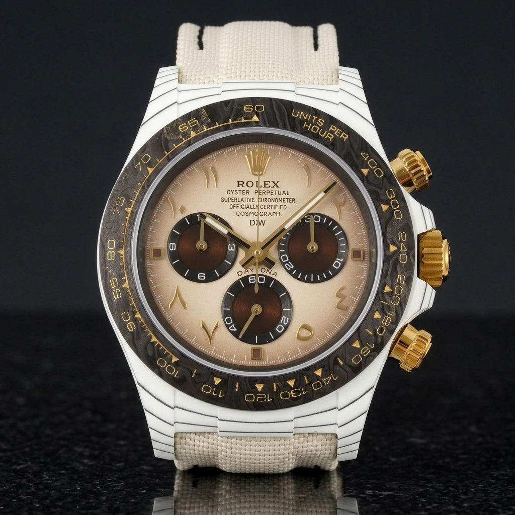 White carbon chronograph with a cream dial on its cream canvas strap, worn on the wrist below a dark suit cuff