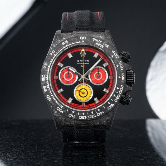 Forged carbon racing chronograph with black and red dial and yellow counter on black granite