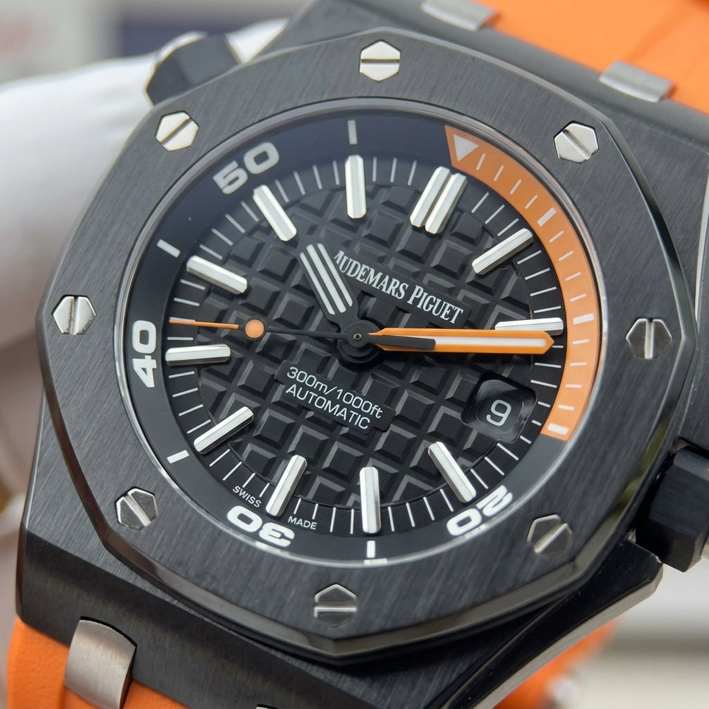 Macro of the black waffle dial, the orange inner dive scale and the crown at ten o'clock