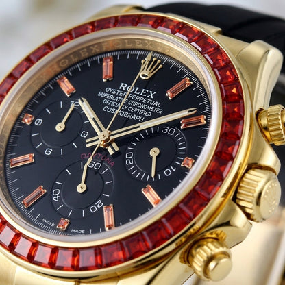 Macro of the black dial with orange baguette-stone markers and three black counters inside the ring of red baguette-cut stones
