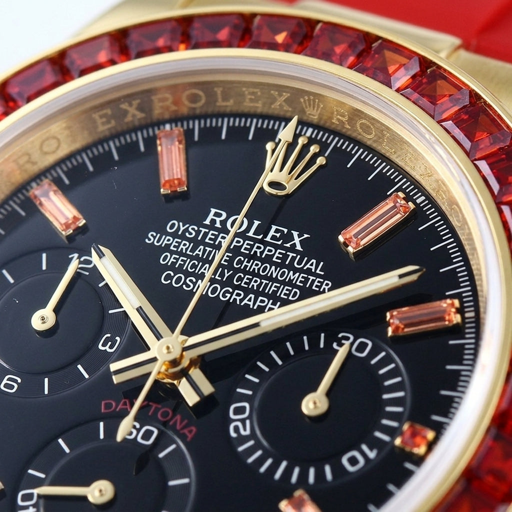 Macro of the black dial with orange stone markers and three black counters inside the ring of red baguette-cut stones