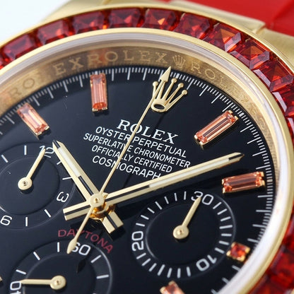 Macro of the black dial with orange stone markers and three black counters inside the ring of red baguette-cut stones
