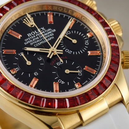 Macro of the black dial, its orange stone markers and white-printed black counters, framed by thirty-six red baguette-cut stones