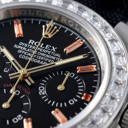 Macro of the black dial with orange baguette-stone markers and three black counters inside the ring of clear baguette stones
