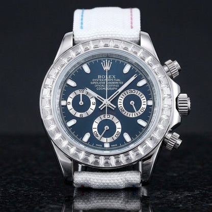 Steel chronograph with a deep blue dial and a bezel of clear baguette-cut stones, upright on polished black granite