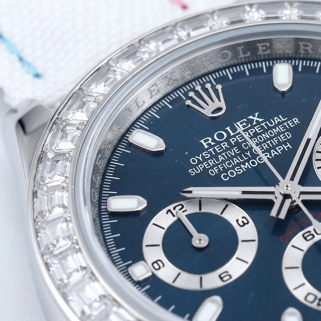 Macro of the deep blue dial with steel baton markers and three silver-ringed counters inside the ring of clear baguette stones