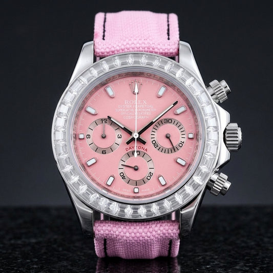 Steel chronograph with a pink dial and a bezel of clear baguette-cut stones, upright on polished black granite